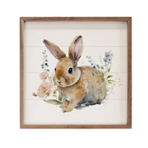 Get ready for Spring with this beautiful mini sign!&nbsp; On a whitewashed wooden background is a sweet watercolor brown bunny sitting amongst pink and purple flowers.

This unique piece is a simple way to bring beauty and charm to any wall or shelf within the home. It is made from high-quality American hardwood planks with a hand-painted face, printed with UV-cured ink, and is framed in a natural walnut frame. Each piece is unique with its own personality, marks, wood grain, and look. Easy to clean with a 