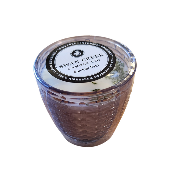 You'll love our cathedral small vase candle. This summer rain candle has been poured into a pretty basketweave purple glass.

Crisp morning dew, with a light earthy tone, this is a perfect summer fragrance!

Filled with 4.5 oz. of American Soybean WaxTM. Measures 3