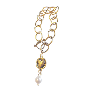 A beautiful gold bracelet to wear on its own or with some of your other favorites! The bracelet has an embossed heart at the end of the link with a pretty pearl accent below.

This 7" link bracelet has a toggle closure.&nbsp;