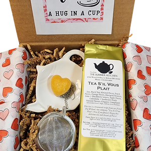 Send a hug with our "Tea, A Hug in a Cup" Tea Box! We've got our Tea S'il Vous Plait blend, black tea in the box that is a delicious caffeinated tea that brews a delicious cup of tea. We also have included a tea ball to brew your tea in and a white ceramic teapot dish to hold your tea ball once your tea is brewed. You'll be able to sweeten your tea with the honey heart included in the box!&nbsp; Send one to your favorite tea person (even if that is YOU) today!

Tea S'il Vous Plait: 2oz, Black Tea: Almond Pi