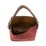 Equally timeless and modern, our best-selling classic hobo is made in rich vegan leather in a beautiful rust faux suede, accented with a brown strap.&nbsp; This roomy bag, accented with a large front pocket and a snap-in removable brown crossbody, has plenty of room to carry your needs in style.