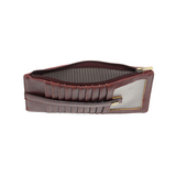 This slim and sleek wallet has nine credit card pockets, each with a snap tab for security and brass-plated hardware. It also has an ID window, zippered change pocket, and zippered billfold pocket in distressed currant vegan leather.


DIMENSIONS: 3.75 IN. H X 7.25 IN. W X .25 IN. D&nbsp;


100% Vegan leather (polyurethane)