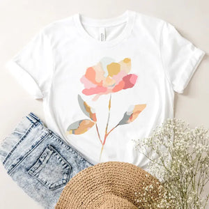 You'll get tons of compliments with this crisp white t-shirt! On the front is a single watercolor flower with stem in a gorgeous watercolor mosaic pattern in several shades of coral and grey blues and grey greens!

Made in the USA
