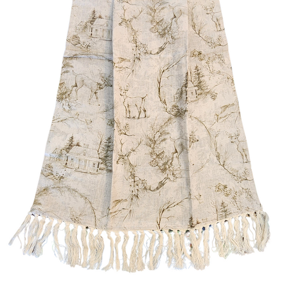 This lovely holiday toile pattern showcases deer, birds, greenery, pinecones, and a cozy house in the woods. Set against beautiful shades of green and grey on soft muslin-cream fabric, the design is completed with a charming cream fringe along the bottom of the towel.

27