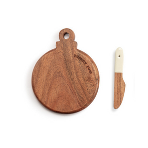 Set the table in style with this mini wood serving board that says "Yummy Yum" at the top. Included is a wooden spreader with a cream handle. It is so fun to serve your favorite cheeses or munchies on, or as a fun gift idea for your favorite foodie!

5"w x 6.5"h

Acacia wood, Handwash Only, Food Safe