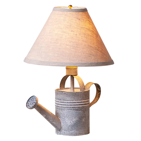 Infuse vintage charm into your country cottage or farmhouse with this delightful Vintage Watering Can Lamp in a weathered zinc finish. Accompanied by a stylish 13-inch beige linen fabric shade, it casts a warm, inviting glow that will uplift your home and brighten your atmosphere. 

6-ft cord. 60 watts maximum bulb.

13.5 x 13.5 x 17.5 in