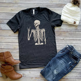 You'll love this soft gray tee with a spunky skeleton that just wants to rock, lol! Printed direct-to-fabric printing for a soft design that won't crack or peel. Shirts are soft Bella and Canvas unisex fashion fit tees that fit like a well-loved favorite, featuring a crew neck and short sleeves.  100% Airlume combed and ring-spun cotton.  Made in the United States
