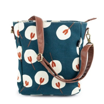 We just LOVE this absolutely adorable floral print! You know all those times you need a free hand, or two? This is the bag for it! Features 3 inner pockets and a strap and hook to attach our pouches. Not to mention, the interior waterproof lining makes cleaning a breeze. Printed on recycled canvas with eco-friendly pigment inks.   Design Inspiration: Hand-drawn, Hand-printed.  Care Instructions: Spot-clean gently as needed  Dimensions: 8.5