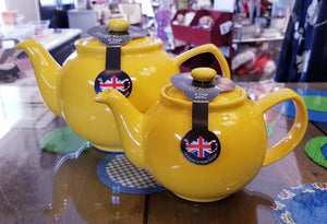 bright yellow teapot in a 2-cup size and a 6-cup size