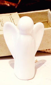 a white porcelain simple guardian angel with two wings, long cylindrical body and round head