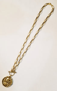 Oh, how we love our Joan of Arc Necklace! This cool gold coin necklace has a toggle in the front for easy on and off.  Necklace 18"  Pendant approx. 1-1/8"w