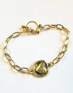 This simple, but elegant bracelet has pretty gold link chains on either side of a beautiful gold embossed heart and has a toggle closure. It is the perfect size to wear every day and can be worn alone or with other bracelets.  7" long
