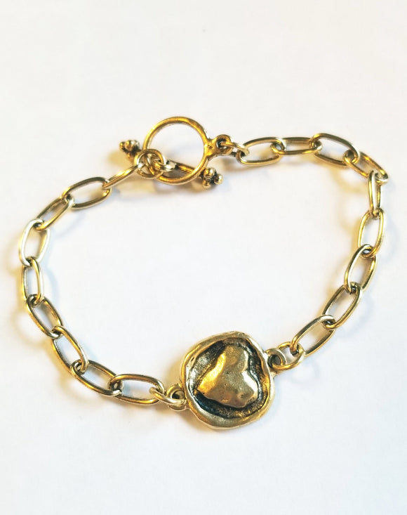 This simple, but elegant bracelet has pretty gold link chains on either side of a beautiful gold embossed heart and has a toggle closure. It is the perfect size to wear every day and can be worn alone or with other bracelets.  7