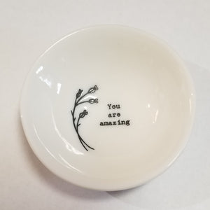 These porcelain trinket bowls are perfect to put your rings in at night, or to put your tea bag or snap mesh ball into when you are done steeping your tea!  "You Are Amazing" is printed on the right side of a sprig of flowers inside of the bowl.  3/4" H x 2 1/2" Dia