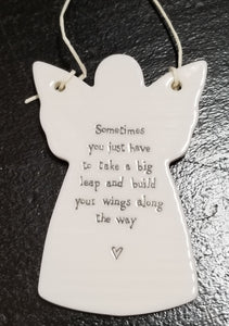 You'll love to give one of these angel-shaped porcelain ornaments to someone special! They have a cord tied to the wings so that it can hang if you would like. The words "Sometimes you just have to take a big leap and build your wings along the way" in a black-type font on the front with a heart below it.  2 3/4" W x 4" H