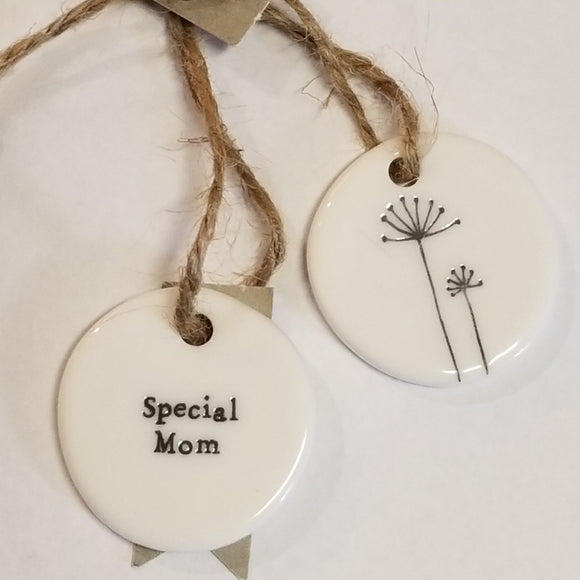 These little porcelain tags are as cute as can be. With a sentiment on one side and a branch with flowers on the other, they have a cord that can be put on a bag or put into a card to give to someone.  1 1/4