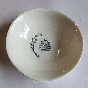 "You have the strength and courage to overcome anythign"  Add a cute decorative piece of love into your home with these handcrafted porcelain wobbly bowls. Each with a ribbed effect and a loving small black line drawn illustration and saying on the inside. A touching gift for a family member or friend to show them your love and appreciation. They are perfect for holding the likes of rings, small trinkets, and various other items.  1 1/4" H x 4" Dia