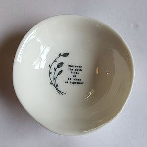 "Wherever the path leads us it keeps us together"  Add a cute decorative piece of love into your home with these handcrafted porcelain wobbly bowls. Each with a ribbed effect and a loving small black line drawn illustration and saying on the inside. A touching gift for a family member or friend to show them your love and appreciation. They are perfect for holding the likes of rings, small trinkets, and various other items.  1 1/4" H x 4" Dia