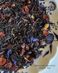 Blended for slow sipping, this black tea has notes of vanilla, malt, and a hint of smoke from the bourbon barrel.   2 oz, Black Tea, Keemun Concerto Tea, Rose Hips, Cocoa Nibs, Lapsang Souchong Tea, Whiskey Flavor, Blue Cornflowers, Natural Candy Apple Flavor, Natural Vanilla Flavor.