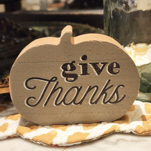 This green wooden pumpkin sitter is perfect to use in your fall decor!  The words "Give Thanks" are written in black with a white highlight. Approximately 3"L x 4"W