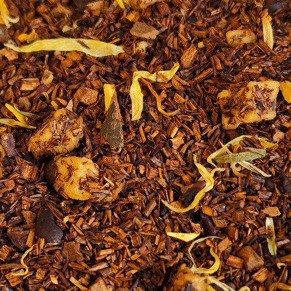 The sweetness of chocolate and caramel are beautifully paired with the nuttiness of pecan, brewing a wonderful cup that is sure to satisfy your sweet tooth!  2oz, Rooibos, Apple Pieces, Cocoa Nibs, Cinnamon, Dark Chocolate Chips, Chicory, Pecan Flavor, Natural Caramel Flavor, Natural Chocolate Flavor & Marigold Flowers.  Caffeine Level: None