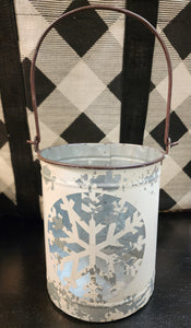 We absolutely LOVE these distressed snowflake metal luminaries!  Set this large one on your mantel, up your staircase, on your table, or buffet with some greenery all winter long.  Don't forget to add a little votive to it for a beautiful soft glow.   Large is approximately 8" h x 6.5" w  The handle is 6.5" tall  Available in two smaller sizes