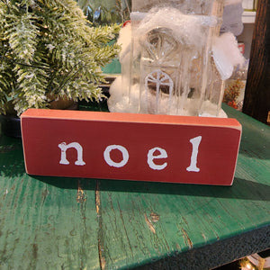 This "Noel" mini sign features a deep red finish with natural wood edges. This freestanding wood block will dress up shelves and tabletops for the holidays!  1.5" h x  5" w x 1/2" d