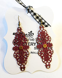 Dainty & sweet, these lightweight filigree earrings will be the prettiest earrings in your jewelry box!  Approximately 2.5" l and 1" w with a 3" total drop.  Hand-painted in a berry color. Lead and Nickel free.