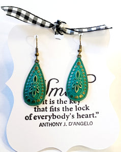 By far, this is one of our favorite pairs of earrings! Featuring a stylized flower surrounded by gradient circles and a beaded edge.  Measures 1 3/8" x 5/8", 2" drop length.  Hand Painted Teal Color. Nickle and Lead Free.