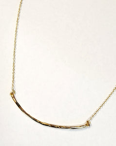 Organic hammered bar necklace in brass and is attached to a chain. The adjustable chain can go from 16" to 18."  Made in India