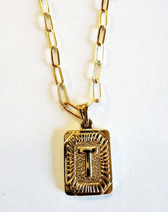 These initial necklaces are one of the hottest looks for this season!  Gold-plated rectangle initial charm with the letter "T" on it comes on a paper clip chain that is 18" long with a 2" extender and a lobster clasp closure.  Made in the USA.