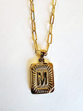 These initial necklaces are one of the hottest looks for this season!  Gold-plated rectangle initial charm with the letter "M" on it comes on a paper clip chain that is 18" long with a 2" extender and a lobster clasp closure.  Made in the USA.