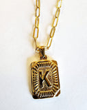 These initial necklaces are one of the hottest looks for this season!  Gold-plated rectangle initial charm with the letter "K" on it comes on a paper clip chain that is 18" long with a 2" extender and a lobster clasp closure.  Made in the USA.