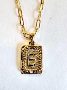 These initial necklaces are one of the hottest looks for this season!  Gold-plated rectangle initial charm with the letter "E" on it comes on a paper clip chain that is 18" long with a 2" extender and a lobster clasp closure.  Made in the USA.