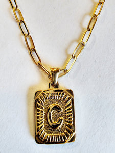 These initial necklaces are one of the hottest looks for this season!  Gold-plated rectangle initial charm with the letter "C" on it comes on a paper clip chain that is 18" long with a 2" extender and a lobster clasp closure.  Made in the USA.