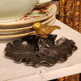 This sweet leaf-shaped pewter dish has a gold bird figurine perched on top. A perfect place to put rings and earrings in at the end of the day!  4.25" L x 4" W x 2" H