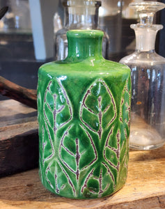 This beautiful green vase is embossed with a pretty leaf design. It will be sure to add a botanist flair to your home. Place your favorite fresh flower inside for an additional pop of color.  4-1/2"H