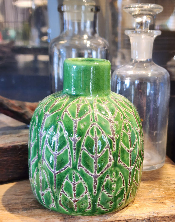 This beautiful green vase is embossed with a pretty leaf design. It will be sure to add a botanist flair to your home. Place your favorite fresh flower inside for an additional pop of color.  3-3/4