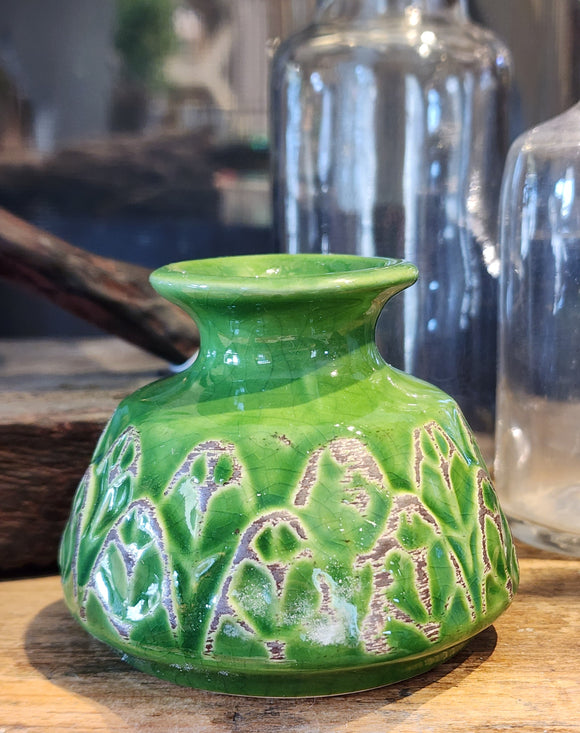 This beautiful green vase is embossed with a pretty leaf design. It will be sure to add a botanist flair to your home. Place your favorite fresh flower inside for an additional pop of color.  2-1/4