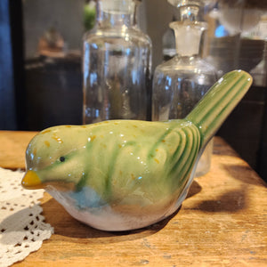 This stoneware green bird will add some sweetness to your decor!  The top is a green glaze with brown speckles scattered throughout.  The breast of the bird has a white glaze with hints of blue. Pair it with our stoneware bird looking up 6" W x 2.5" D  x 3.75" H