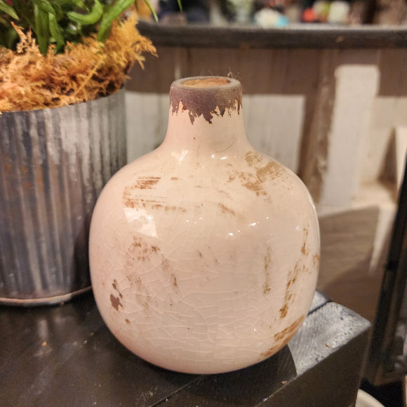 Our mini vases are distressed, crackled, and come in the most beautiful shades! This white one will look fabulous in your home with a little floral or greenery!  Ceramic  Approximately 3.75