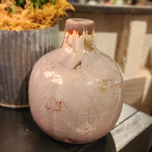 Our mini vases are distressed and crackled and come in the most beautiful shades! This lilac one will look fabulous in your home with a little floral or a bit of greenery!  Ceramic  Approximately 3.75" H x 3" W