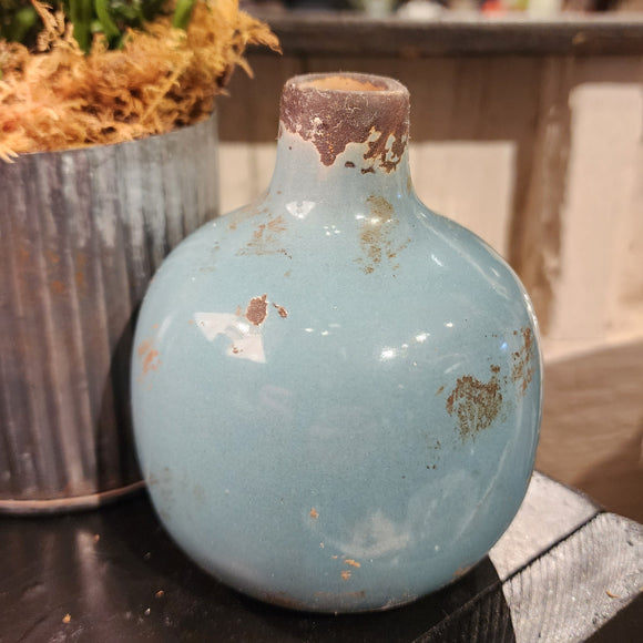 Our mini vases are distressed and crackled and come in the most beautiful shades! This teal one will look fabulous in your home with a little floral or a bit of greenery!  Ceramic  Approximately 3.75