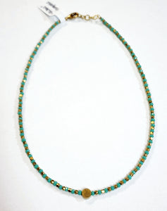 This choker is so pretty and will look great layered or worn alone!  Brass and multi-colored grey faceted beads alternate and meet in the center will a circular brass bead for a fun detail!  There is a lobster clasp closure with room to adjust the size of the necklace from 14.5" - 15"    Handmade by a young designer and team of artists in Northern India