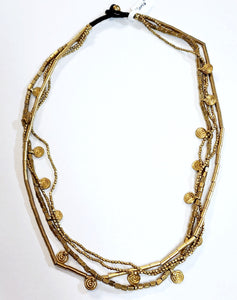 Now here is a gorgeous layered brass necklace!  The first layer is two small beaded strands, the second layer is beautiful long brass beads, and the final layer is rectangular beads with circle disc charms spaced apart.  This will be your go-to necklace! The hook is a brown cord with a brass bead that goes through the loop to close around your neck.  23" long  Handmade by a young designer and team of artists in Northern India
