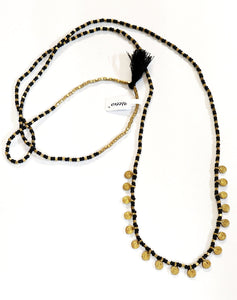 Absolutely stunning!  This black and brass beaded necklace has brass charms along the bottom with a black tassel on the top in between a line of squared brass beads. Perfect for layering or wearing alone!  22" long  Handmade by a young designer and team of artists in Northern India