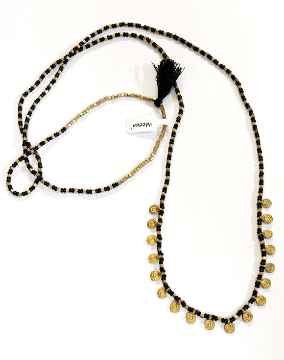 Absolutely stunning!  This black and brass beaded necklace has brass charms along the bottom with a black tassel on the top in between a line of squared brass beads. Perfect for layering or wearing alone!  22