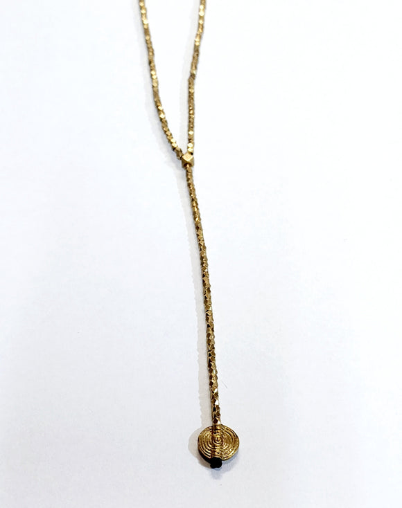Simplicity is always good! This beautiful lariat necklace is made up of small brass faceted beads at the bottom of the necklace hangs a single 4.5