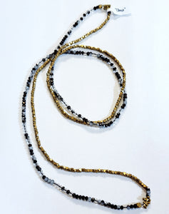 Gorgeous! This necklace is just a fun piece and a new favorite at The Summer Kitchen. It has beautiful brass small diamond-shaped beads mixed with faceted black, clear, and grey-toned beads and a few brass toggled beads thrown in for fun.  Lots of light plays off of this necklace!   We even like to double this one up to create a layered look as well!  50" beaded necklace hangs down 25" long  Handmade by a young designer and team of artists in Northern India