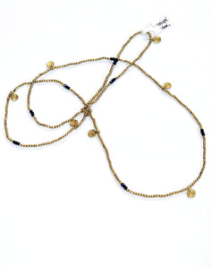 A beautiful 34" layering necklace with brass beads accented with several sets of three glass blue beads, making a beautiful pattern around the necklace.  In between the blue glass beads are brass circle charms.  Handmade by a young designer and team of artists in Northern India.  17" drop    